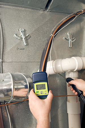 Repairman Checks Carbon Monoxide Level on Furnace Duct