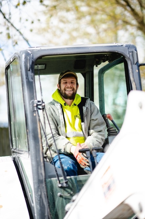 Hope Plumbing employee in the excavator