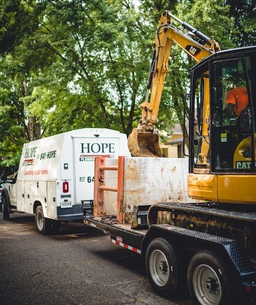 Hope Plumbing excavator on a trailer